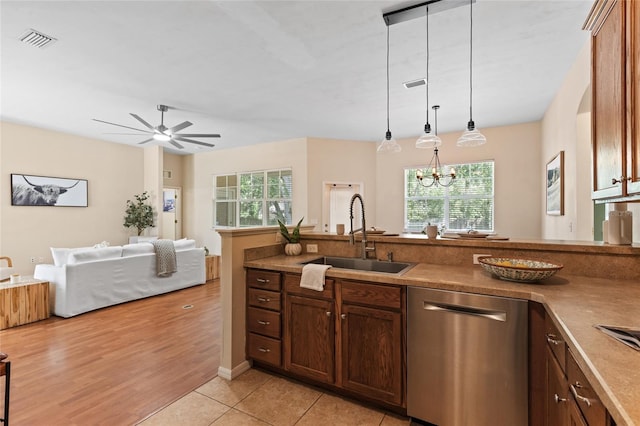 8360 SW 74th Pl, Gainesville, FL 32608 - kitchen featuring stainless steel dishwasher, a sink, a ceiling fan, decorative light fixtures, and open floor plan