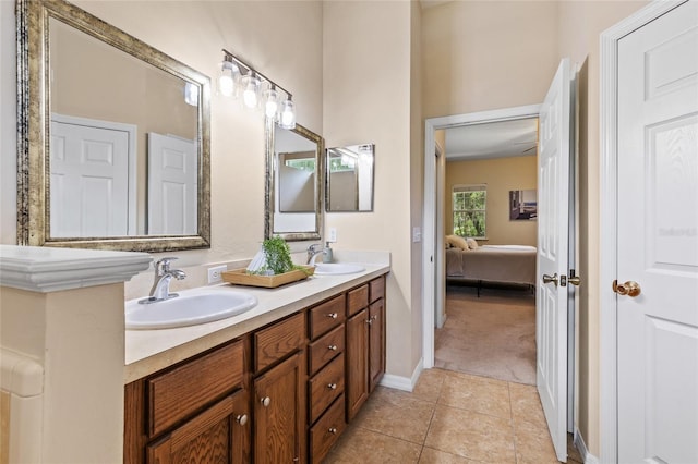 8360 SW 74th Pl, Gainesville, FL 32608 - bathroom featuring double vanity, connected bathroom, tile patterned flooring, and baseboards