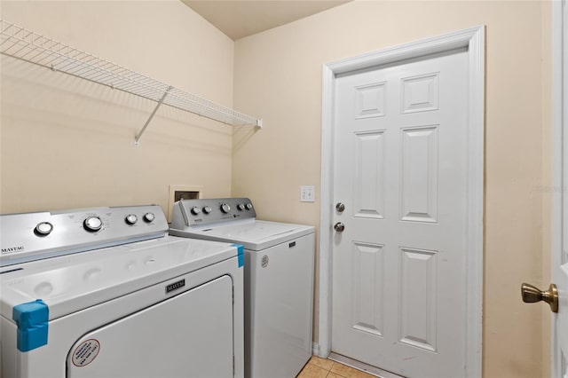8360 SW 74th Pl, Gainesville, FL 32608 - washroom with washer and clothes dryer and light tile patterned floors