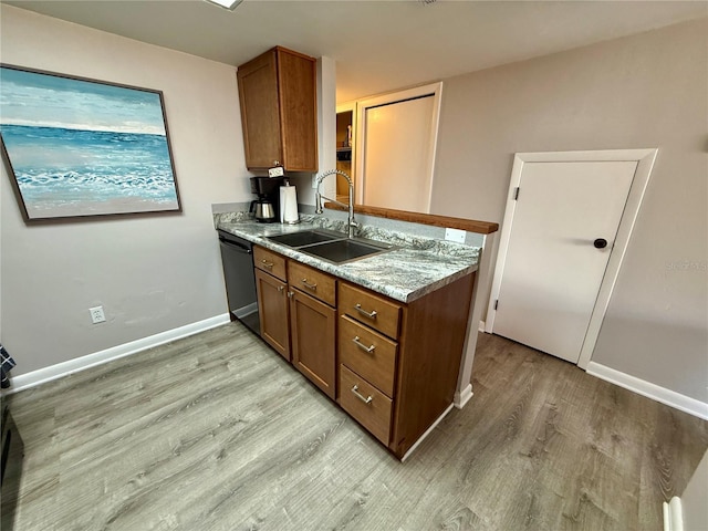 2058 SW 35th Pl Unit H47, Gainesville, FL 32608 - kitchen featuring a sink, dishwasher, brown cabinets, light wood-style flooring, and baseboards