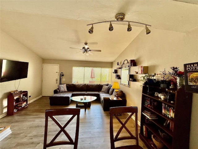2058 SW 35th Pl Unit H47, Gainesville, FL 32608 - living room with vaulted ceiling, ceiling fan, wood finished floors, and baseboards