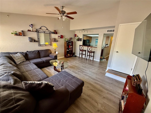 2058 SW 35th Pl Unit H47, Gainesville, FL 32608 - living area featuring ceiling fan, wood finished floors, vaulted ceiling, and baseboards