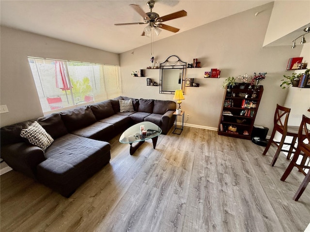 2058 SW 35th Pl Unit H47, Gainesville, FL 32608 - living room featuring wood finished floors, vaulted ceiling, ceiling fan, and baseboards
