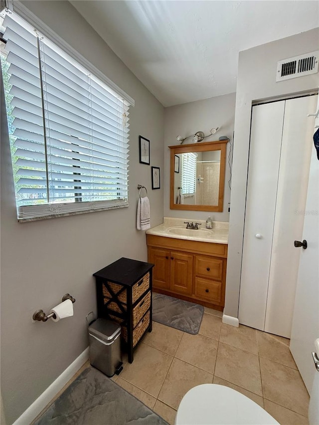 2058 SW 35th Pl Unit H47, Gainesville, FL 32608 - bathroom featuring toilet, vanity, baseboards, and tile patterned floors