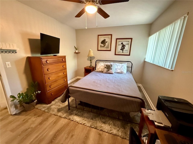 2058 SW 35th Pl Unit H47, Gainesville, FL 32608 - bedroom with wood finished floors, ceiling fan, and baseboards