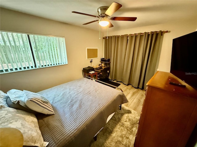 2058 SW 35th Pl Unit H47, Gainesville, FL 32608 - bedroom with light wood finished floors and ceiling fan