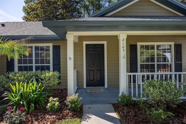 8103 SW 71st Ln, Gainesville, FL 32608 - view of exterior entry featuring covered porch and roof with shingles