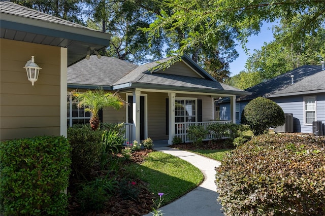 8103 SW 71st Ln, Gainesville, FL 32608 - view of front of home with a porch, roof with shingles, and central AC