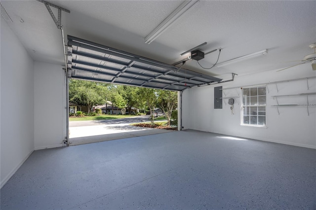 8103 SW 71st Ln, Gainesville, FL 32608 - garage featuring electric panel, baseboards, a garage door opener, and ceiling fan