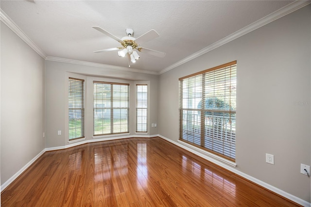 8103 SW 71st Ln, Gainesville, FL 32608 - spare room featuring wood finished floors, a ceiling fan, baseboards, and crown molding