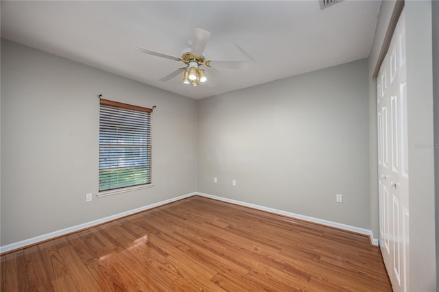 8103 SW 71st Ln, Gainesville, FL 32608 - spare room featuring baseboards, light wood finished floors, and a ceiling fan