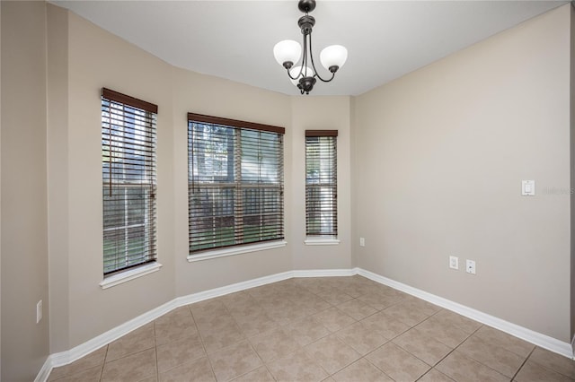 8103 SW 71st Ln, Gainesville, FL 32608 - unfurnished room featuring light tile patterned flooring, baseboards, and a chandelier
