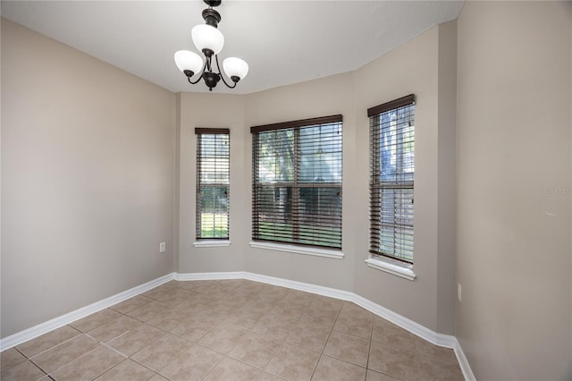 8103 SW 71st Ln, Gainesville, FL 32608 - spare room with light tile patterned flooring, plenty of natural light, and a chandelier