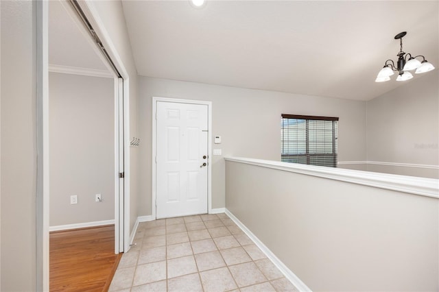 8103 SW 71st Ln, Gainesville, FL 32608 - foyer featuring baseboards, a chandelier, and light tile patterned floors