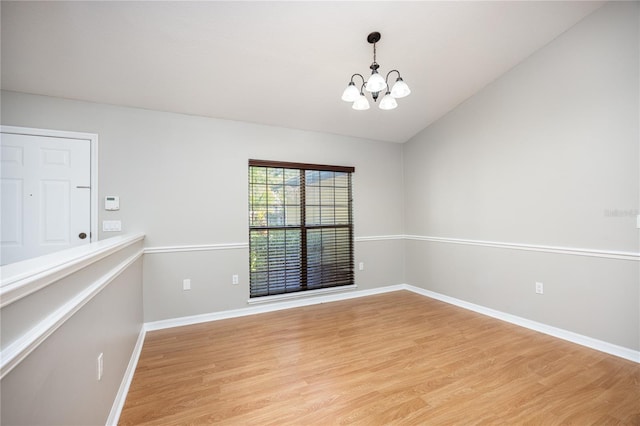 8103 SW 71st Ln, Gainesville, FL 32608 - spare room with a chandelier, light wood-style floors, baseboards, and lofted ceiling