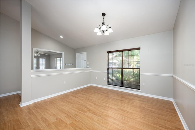 8103 SW 71st Ln, Gainesville, FL 32608 - spare room with light wood finished floors, healthy amount of natural light, a chandelier, lofted ceiling, and baseboards