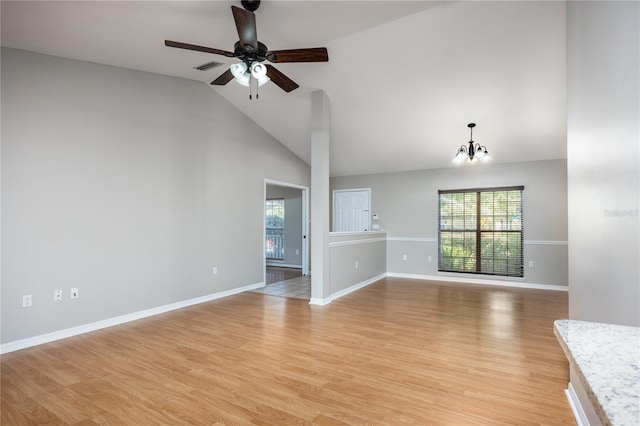 8103 SW 71st Ln, Gainesville, FL 32608 - unfurnished living room featuring healthy amount of natural light, a ceiling fan, high vaulted ceiling, a chandelier, and light wood finished floors