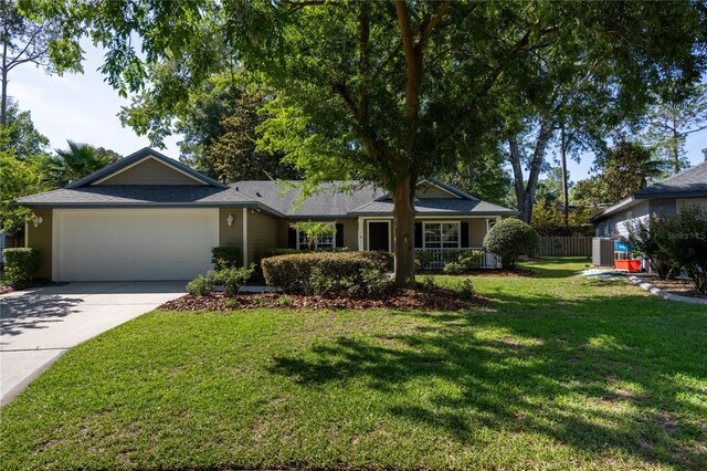 8103 SW 71st Ln, Gainesville, FL 32608 - single story home with an attached garage and driveway