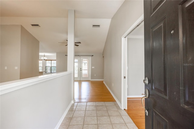 8103 SW 71st Ln, Gainesville, FL 32608 - foyer entrance featuring light tile patterned floors, ceiling fan, a chandelier, baseboards, and french doors