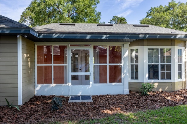 8103 SW 71st Ln, Gainesville, FL 32608 - rear view of property featuring roof with shingles and a sunroom