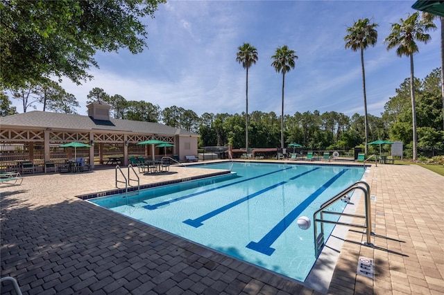 8103 SW 71st Ln, Gainesville, FL 32608 - community pool featuring a patio and view of scattered trees