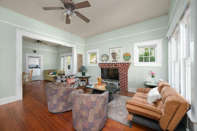 119 NW 7th Ter, Gainesville, FL 32601 - living area featuring a ceiling fan, wood finished floors, a brick fireplace, and baseboards