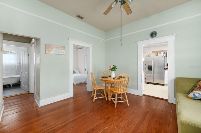 119 NW 7th Ter, Gainesville, FL 32601 - dining room featuring wood finished floors, ceiling fan, and baseboards