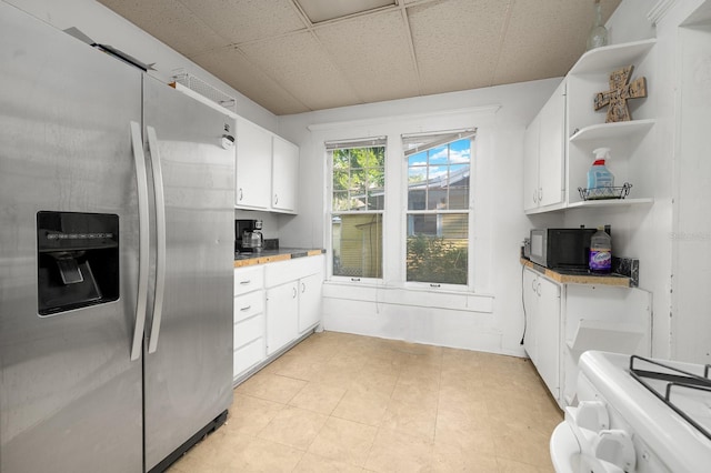 119 NW 7th Ter, Gainesville, FL 32601 - kitchen featuring stainless steel refrigerator with ice dispenser, open shelves, range, white cabinets, and black microwave