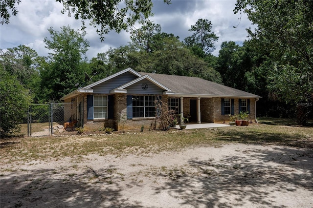1841 SE 245th St, Hawthorne, FL 32640 - ranch-style home featuring brick siding and a gate