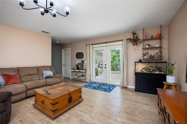 1841 SE 245th St, Hawthorne, FL 32640 - living area with light wood-style flooring, a chandelier, french doors, and baseboards
