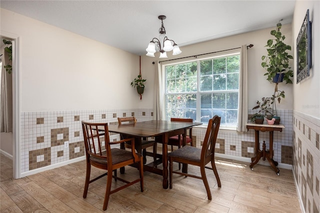 1841 SE 245th St, Hawthorne, FL 32640 - dining room featuring tile walls, a wainscoted wall, light wood-style flooring, and a chandelier