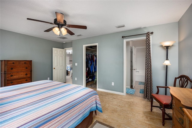 1841 SE 245th St, Hawthorne, FL 32640 - bedroom with light wood-style flooring, a walk in closet, a closet, a ceiling fan, and baseboards