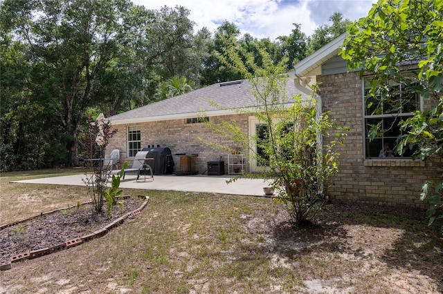 1841 SE 245th St, Hawthorne, FL 32640 - back of house with a patio area, brick siding, and a lawn