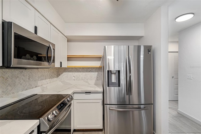 2735 SW 35th Pl Unit 1905, Gainesville, FL 32608 - kitchen featuring stainless steel appliances, open shelves, tasteful backsplash, white cabinetry, and light stone counters