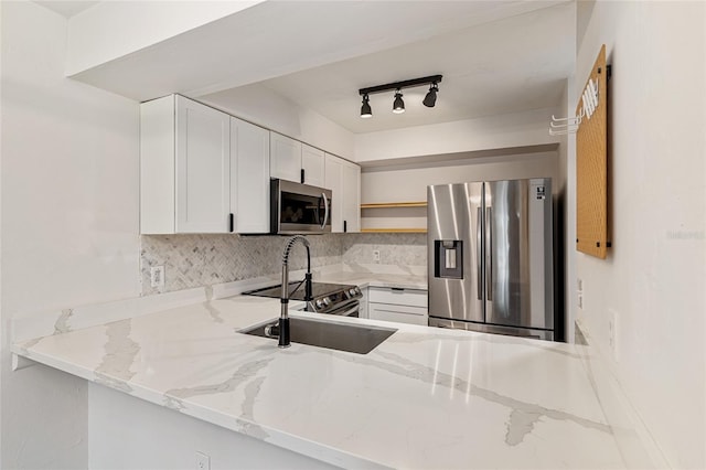 2735 SW 35th Pl Unit 1905, Gainesville, FL 32608 - kitchen with appliances with stainless steel finishes, open shelves, tasteful backsplash, and light stone countertops