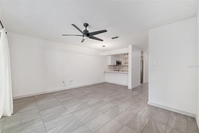 2735 SW 35th Pl Unit 1905, Gainesville, FL 32608 - unfurnished living room featuring a ceiling fan and baseboards