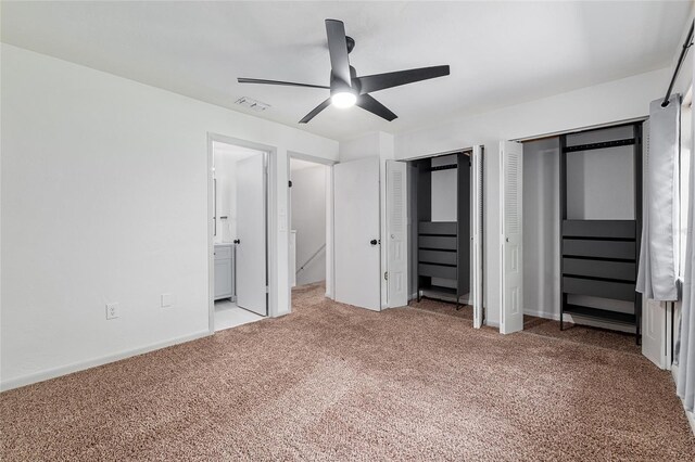 2735 SW 35th Pl Unit 1905, Gainesville, FL 32608 - unfurnished bedroom with two closets, light colored carpet, ensuite bath, and ceiling fan