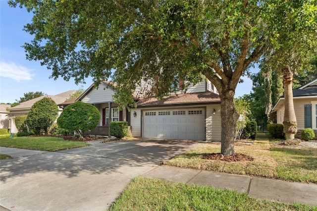 8877 SW 80th Ave, Gainesville, FL 32608 - view of property hidden behind natural elements with concrete driveway, a front lawn, and an attached garage