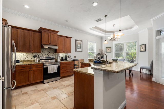 8877 SW 80th Ave, Gainesville, FL 32608 - kitchen with appliances with stainless steel finishes, a sink, under cabinet range hood, stone countertops, and brown cabinetry
