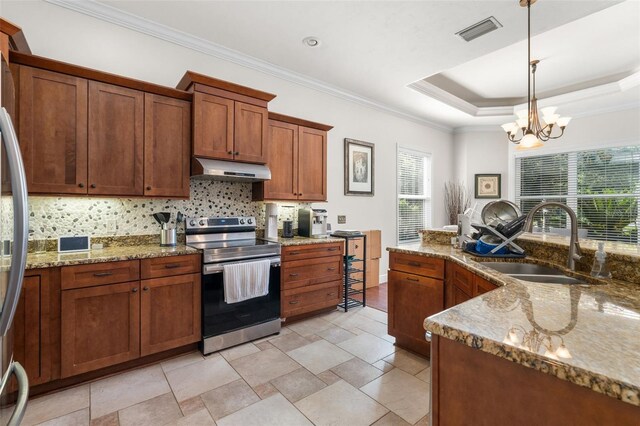 8877 SW 80th Ave, Gainesville, FL 32608 - kitchen featuring stainless steel appliances, a sink, under cabinet range hood, tasteful backsplash, and brown cabinetry