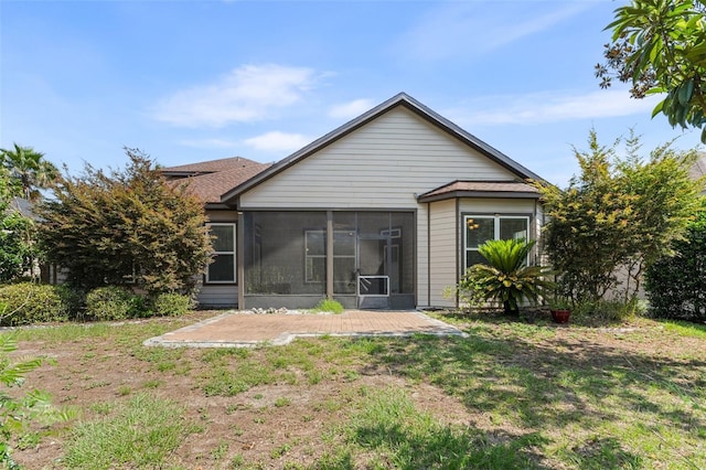 8877 SW 80th Ave, Gainesville, FL 32608 - back of property with a sunroom, a patio area, and a yard