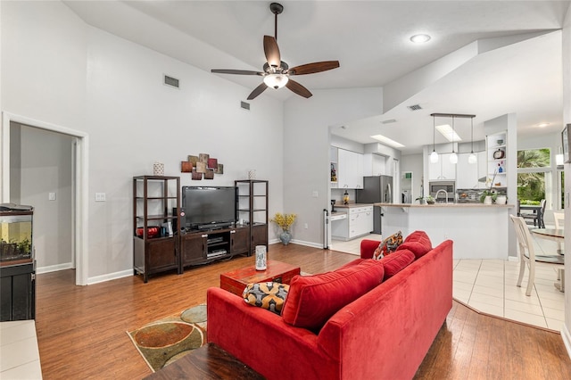 13615 SW 1st Ln, Newberry, FL 32669 - living area featuring high vaulted ceiling, a ceiling fan, wood finished floors, and baseboards
