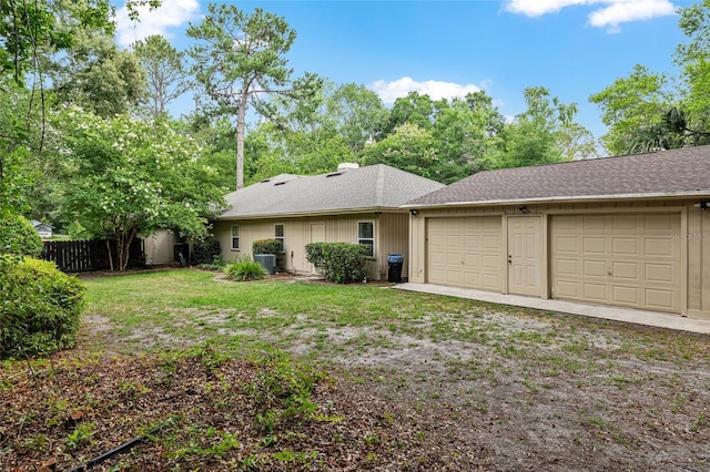 13615 SW 1st Ln, Newberry, FL 32669 - back of property with an attached garage, driveway, and roof with shingles