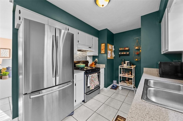 4510 NW 27th Ter, Gainesville, FL 32605 - kitchen with stainless steel appliances, under cabinet range hood, light countertops, white cabinets, and a sink