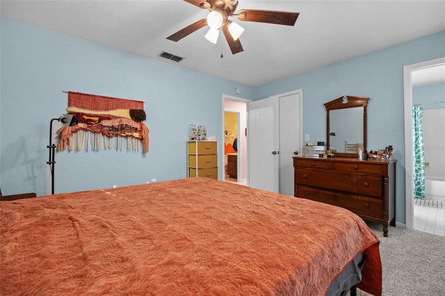 4510 NW 27th Ter, Gainesville, FL 32605 - carpeted bedroom featuring a ceiling fan and ensuite bathroom
