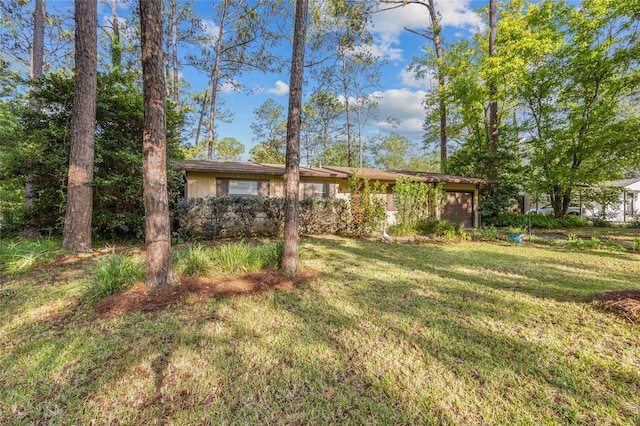 4510 NW 27th Ter, Gainesville, FL 32605 - view of green lawn featuring an attached garage