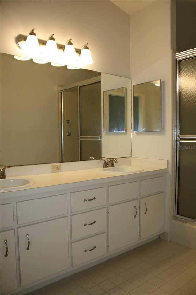 7518 NW 35th Pl, Gainesville, FL 32606 - bathroom featuring tile patterned floors, double vanity, and a shower stall