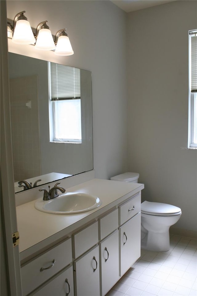 7518 NW 35th Pl, Gainesville, FL 32606 - bathroom with vanity, plenty of natural light, tile patterned floors, and toilet
