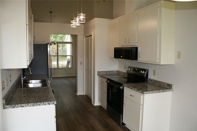 7518 NW 35th Pl, Gainesville, FL 32606 - kitchen with black appliances, a sink, dark wood-style floors, baseboards, and white cabinets