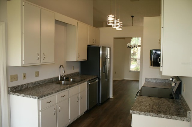 7518 NW 35th Pl, Gainesville, FL 32606 - kitchen with a sink, appliances with stainless steel finishes, a chandelier, dark wood-style floors, and white cabinetry